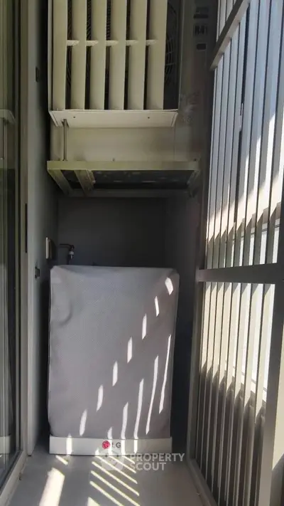 Compact balcony with air conditioning unit in modern apartment