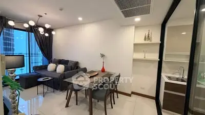 Modern living room with dining area and open kitchen in a stylish apartment.