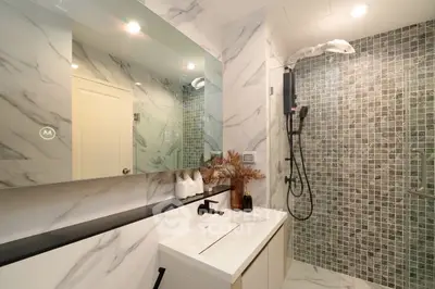 Luxurious modern bathroom with marble walls and sleek fixtures