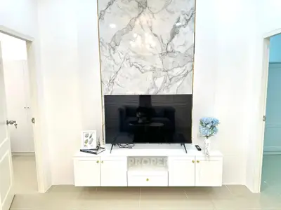 Modern living room with marble accent wall and sleek TV setup