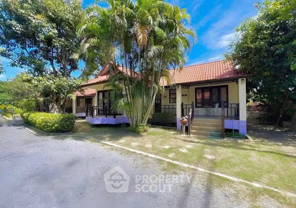 Charming tropical bungalow with lush garden and inviting entrance