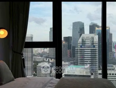 Stunning cityscape view from a modern bedroom window in a high-rise apartment.