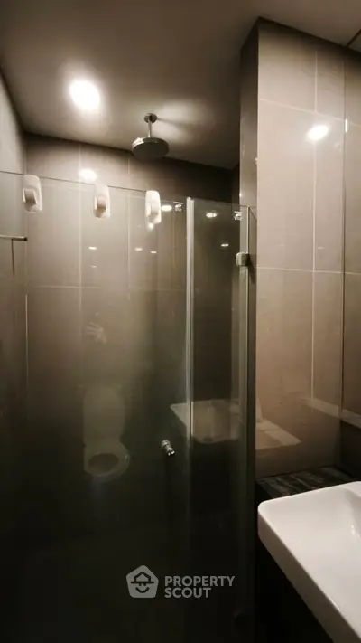 Modern bathroom with glass shower enclosure and sleek fixtures
