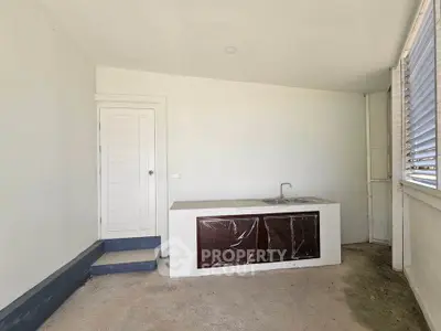 Minimalist kitchen space with closed layout and sleek cabinetry