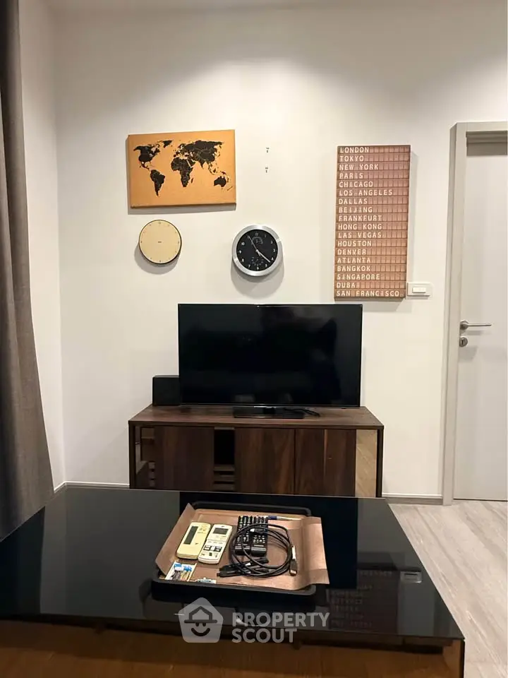 Modern living room with stylish decor and wall-mounted TV, perfect for cozy evenings.