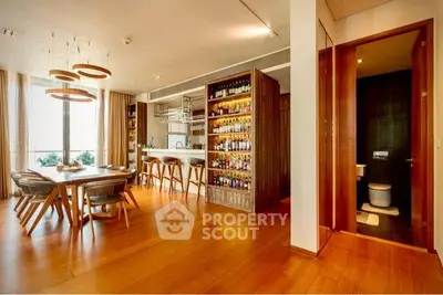 Luxurious open-plan dining area with stylish bar and wooden flooring