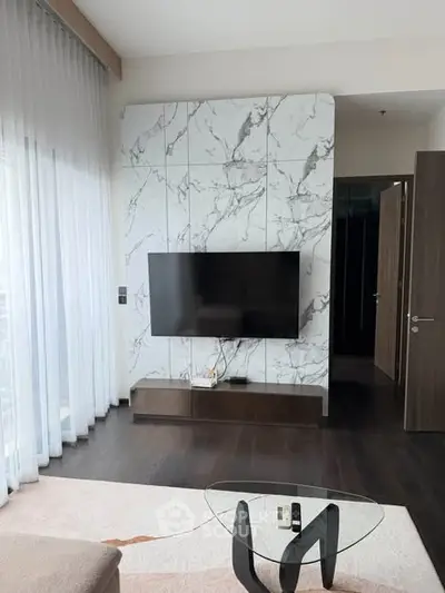 Modern living room with marble accent wall and sleek TV setup