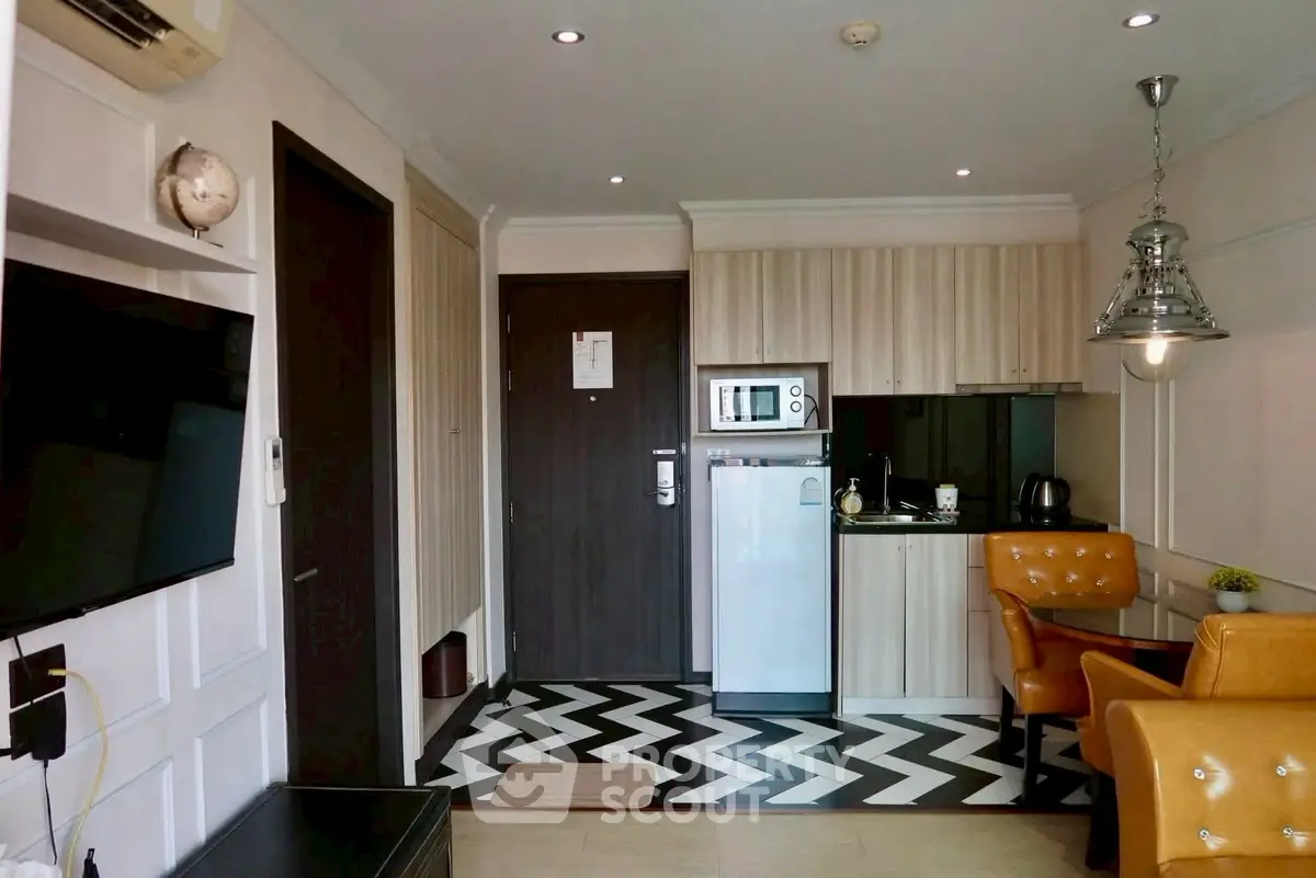 Chic modern kitchen with stylish chevron flooring and cozy dining area.
