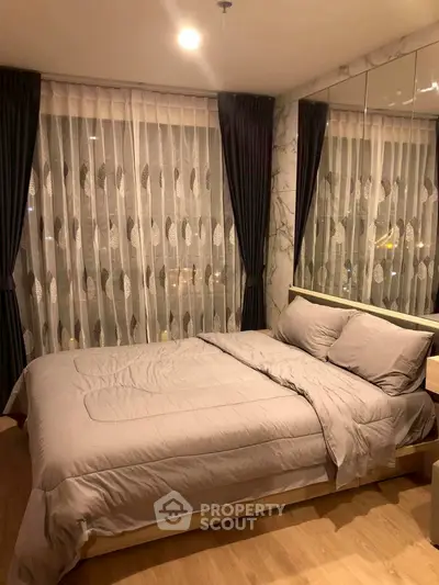 Cozy bedroom with elegant curtains and soft lighting, perfect for relaxation and comfort.