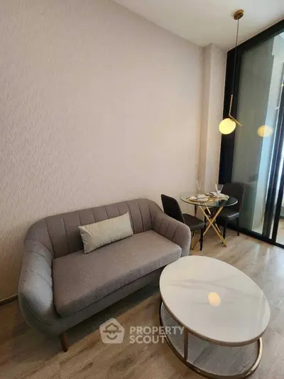 Modern living room with stylish sofa and elegant dining area in a cozy apartment.