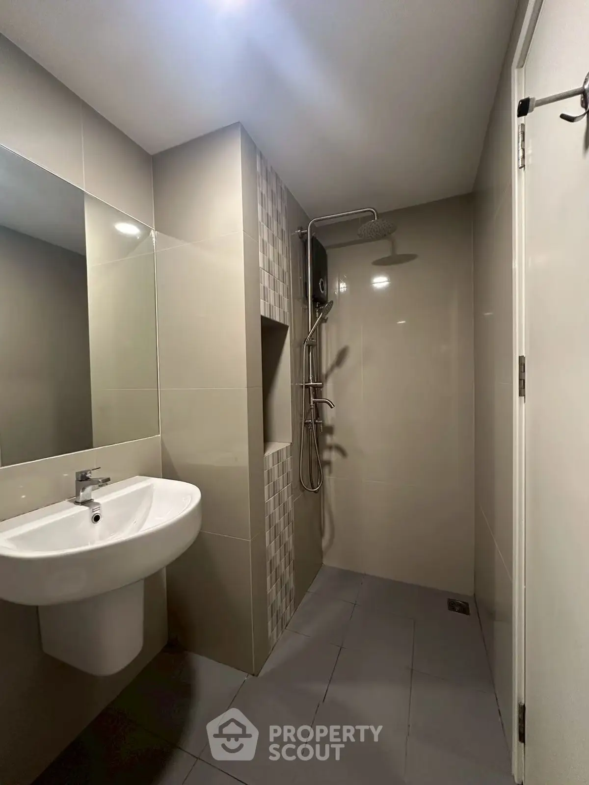 Modern bathroom with sleek shower and sink in contemporary design.