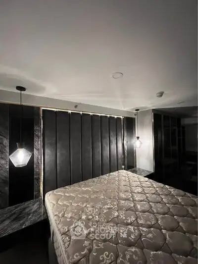 Luxurious bedroom with elegant lighting and plush mattress in modern design.