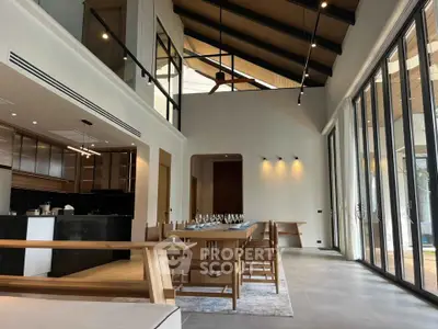 Luxurious open-plan living room with high ceilings and modern dining area