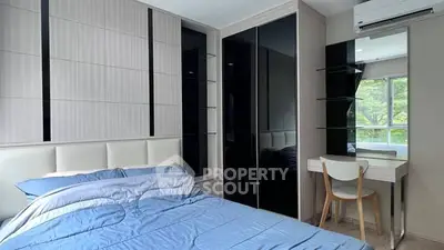 Modern bedroom with sleek design, featuring a large bed and stylish wardrobe.