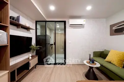 Modern living room with sleek design, featuring a green sofa, wall-mounted TV, and stylish decor.