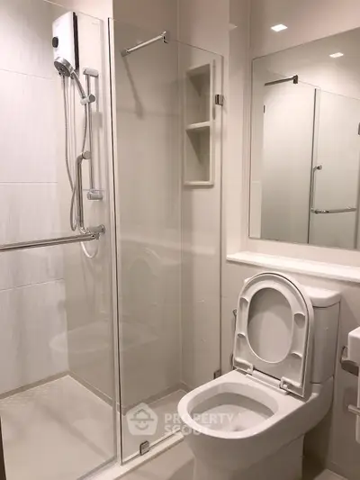 Modern bathroom with glass shower enclosure and sleek fixtures