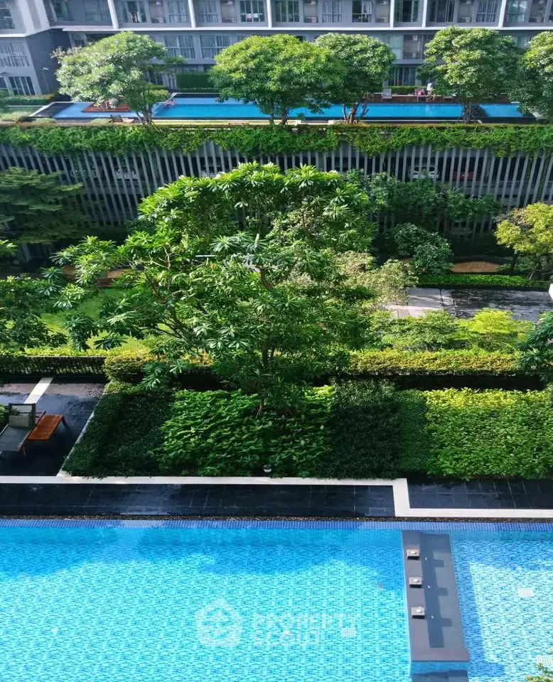 Luxurious condominium with lush gardens and sparkling swimming pool, offering serene urban living.