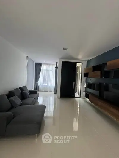 Spacious modern living room with sleek furniture and large windows