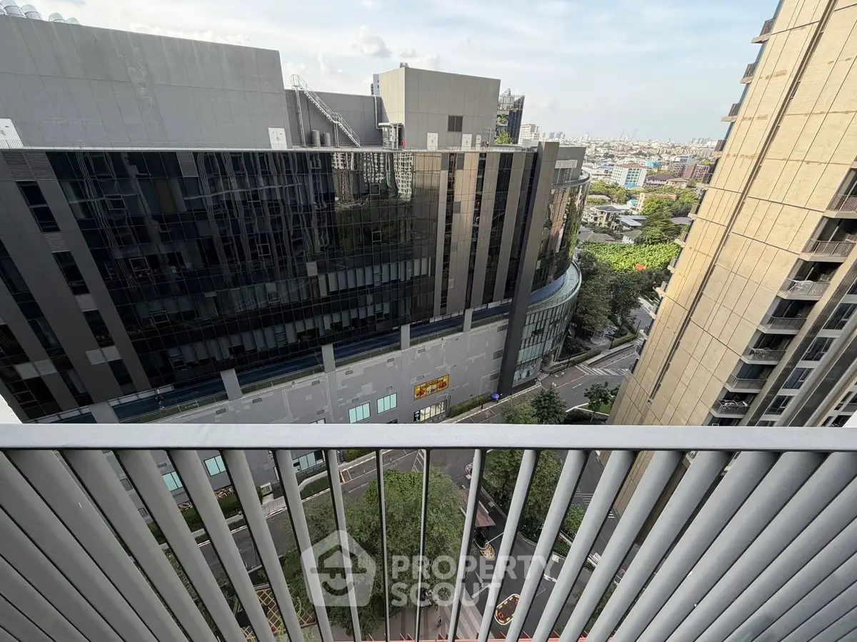 Stunning urban view from a high-rise balcony overlooking modern cityscape.