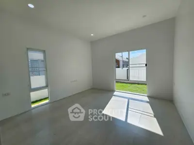 Spacious sunlit room with large windows and modern flooring, ideal for customization.