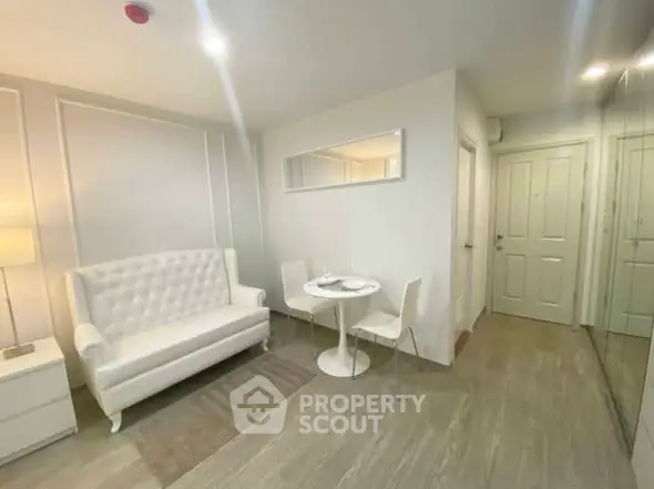 Chic modern living room with elegant white sofa and dining set