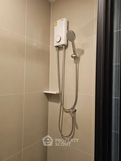 Modern bathroom with sleek shower unit and neutral tiles