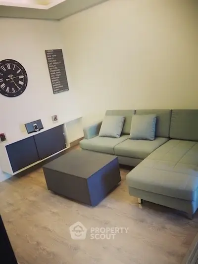 Modern living room with stylish furniture and wall clock, perfect for relaxation.