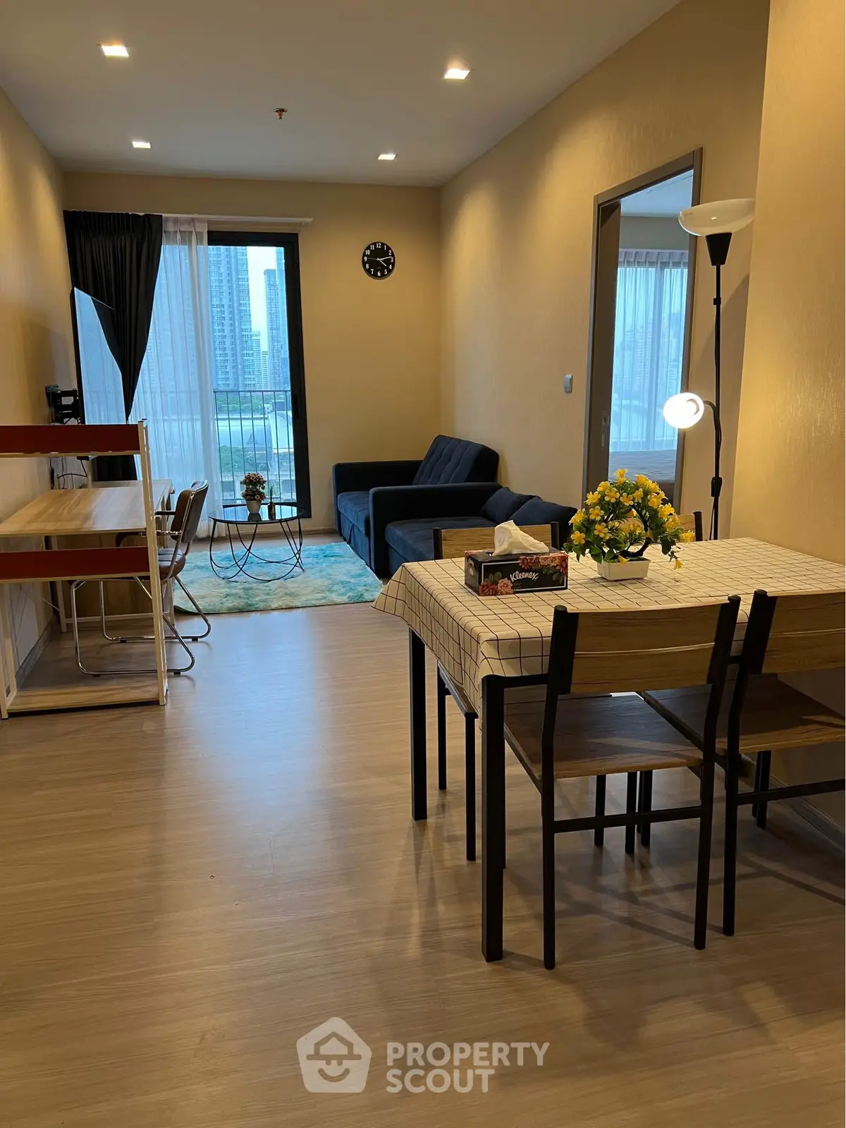 Modern living room with dining area and balcony view in a stylish apartment.