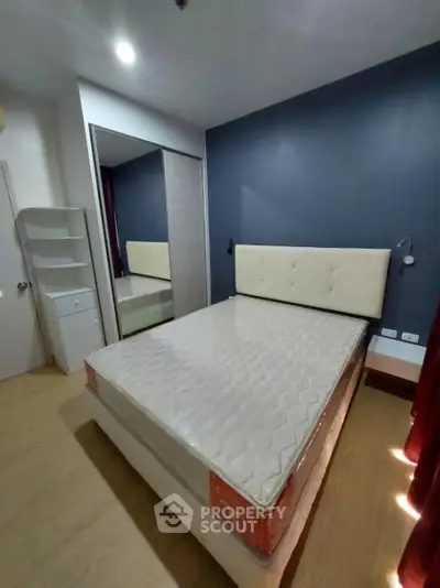 Modern bedroom with stylish decor and comfortable bed in a cozy apartment.