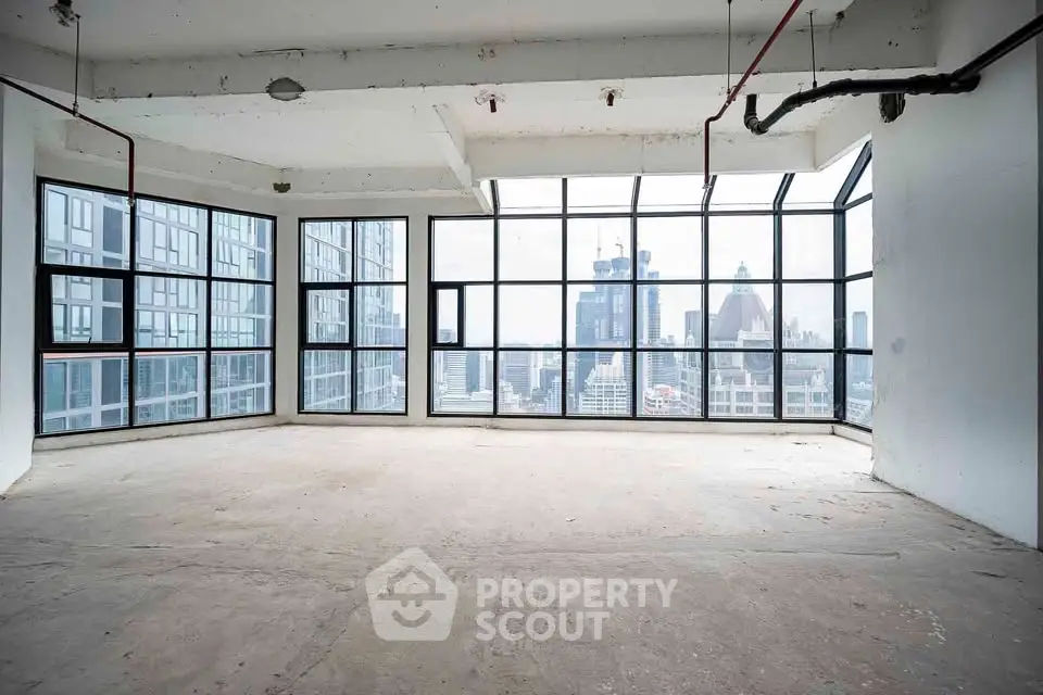 Spacious corner unit with floor-to-ceiling windows offering stunning city views in a modern high-rise building.