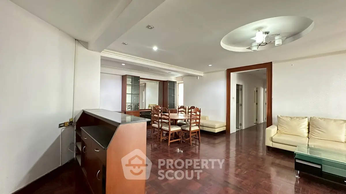 Spacious living room with elegant wooden flooring and modern ceiling design