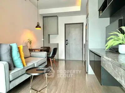 Modern living room with stylish decor and open layout, featuring cozy seating and elegant lighting.