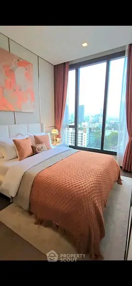 Luxurious bedroom with floor-to-ceiling windows offering stunning city views, elegant decor, and cozy ambiance.
