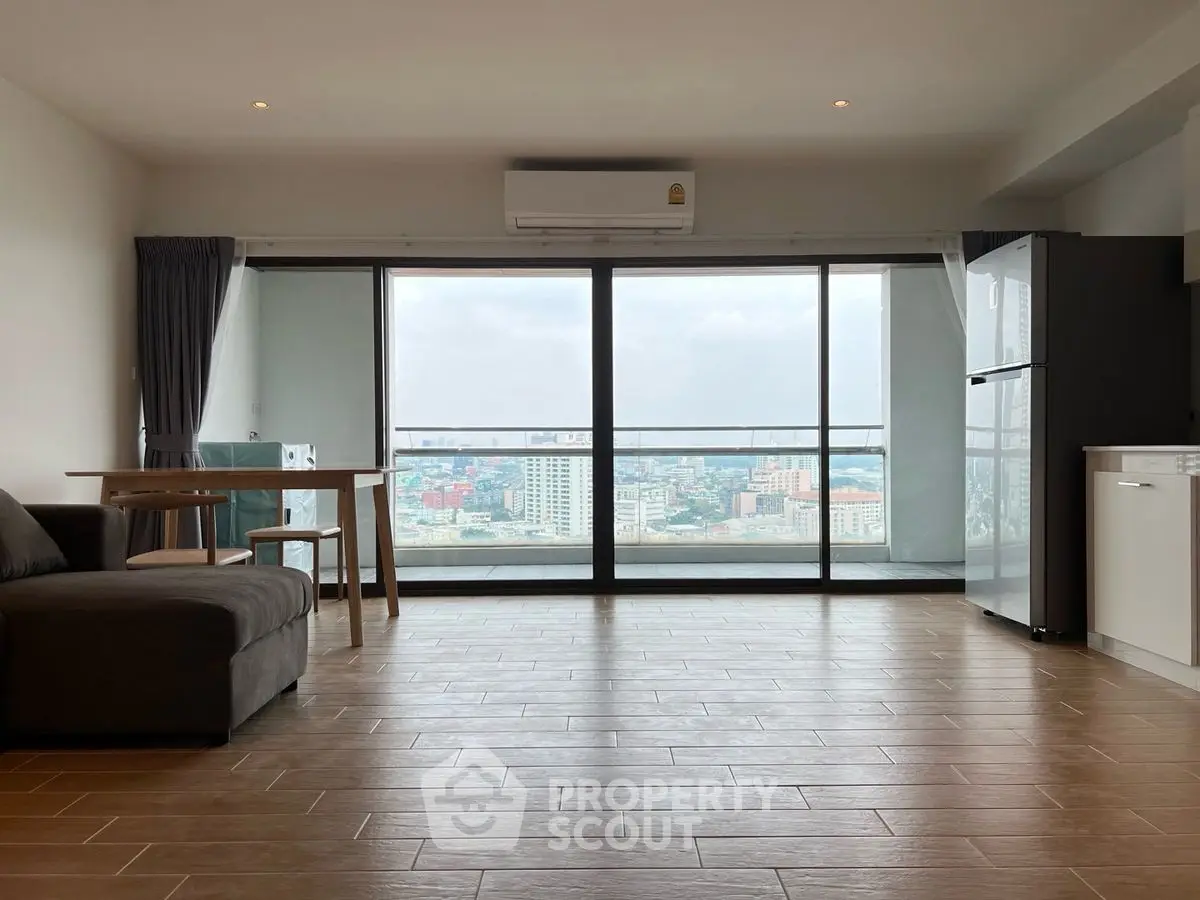 Spacious living room with city view and modern furnishings