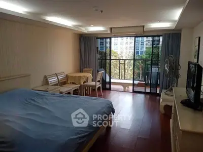 Spacious bedroom with balcony and natural light in modern apartment