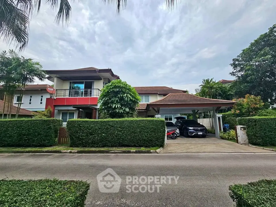 Stunning two-story house with lush greenery and spacious driveway in serene neighborhood.