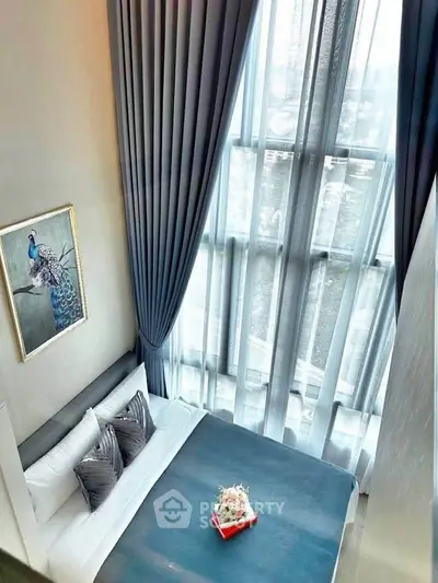 Luxurious bedroom with high ceilings and large windows offering stunning views.