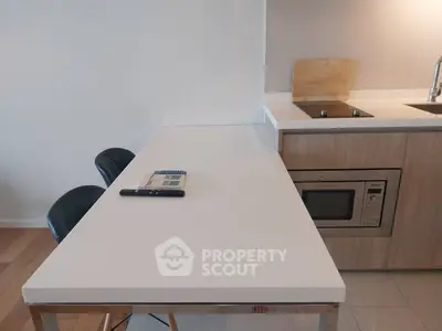 Modern kitchen with sleek countertop and built-in appliances