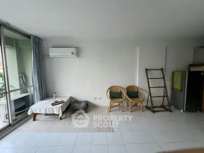 Spacious living room with minimalist decor and large window for natural light.