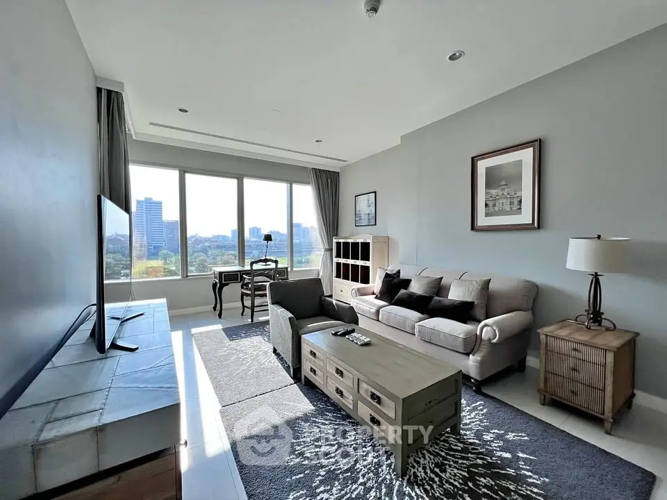 Spacious modern living room with large windows and stylish furniture, offering a bright and inviting atmosphere.