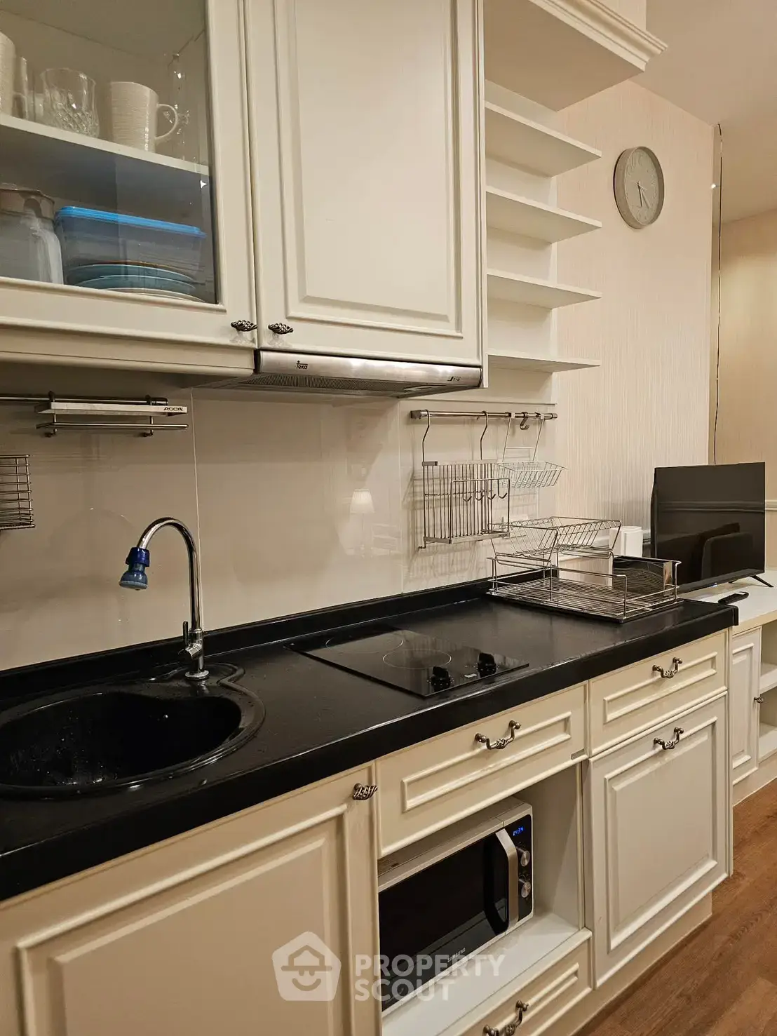 Charming kitchen with modern appliances and elegant cabinetry, perfect for culinary enthusiasts.