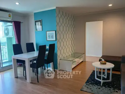 Modern living room with stylish dining area and balcony view