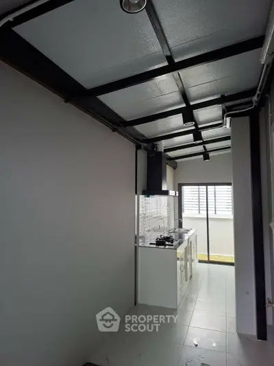 Modern kitchen with sleek design and open layout, featuring gas stove and ample natural light.