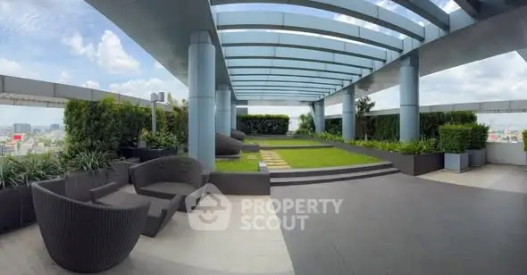 Luxurious rooftop garden with modern seating and panoramic city views.