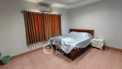 Spacious bedroom with elegant curtains and air conditioning in a modern home.
