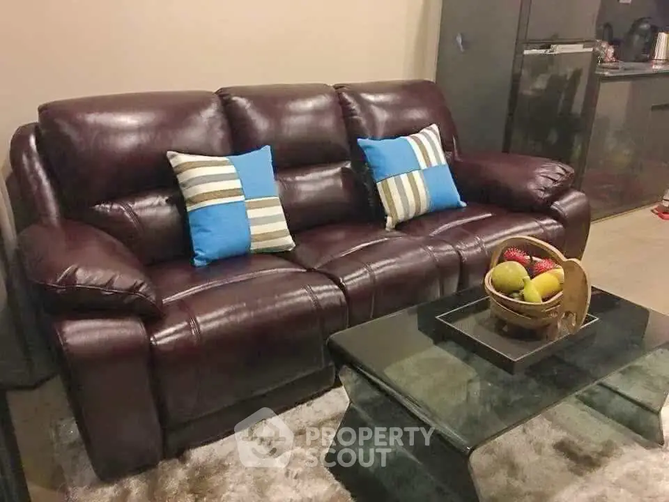 Stylish living room with leather sofa and modern glass coffee table