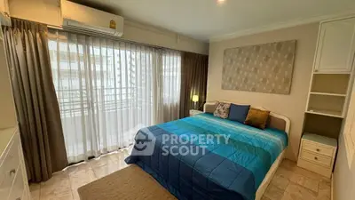 Cozy bedroom with large window and modern decor in a stylish apartment.
