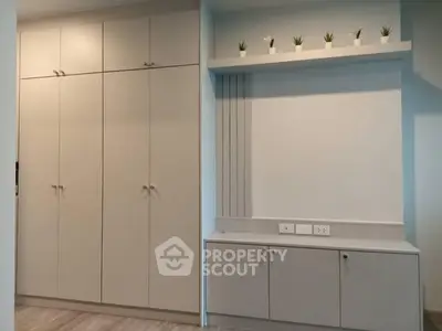 Modern storage space with sleek cabinets and decorative plants