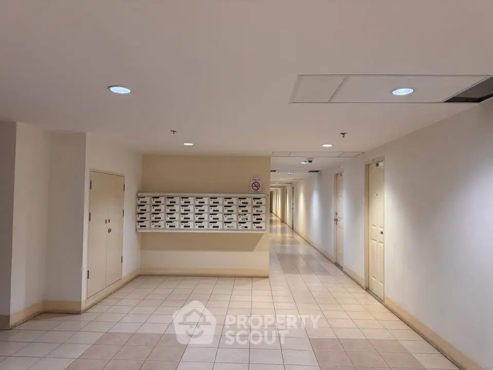 Spacious apartment hallway with mailboxes and tiled flooring