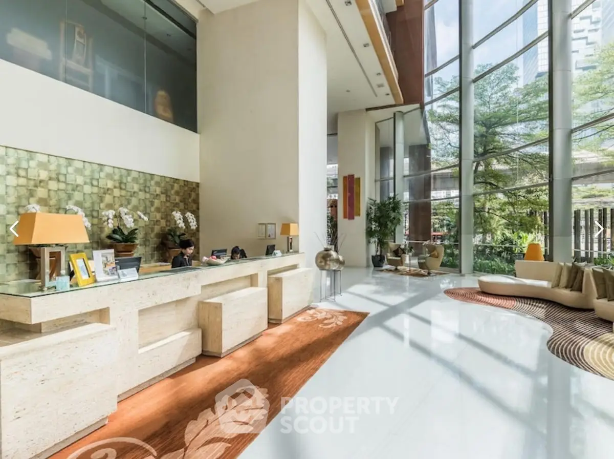 Luxurious hotel lobby with modern design and floor-to-ceiling windows.
